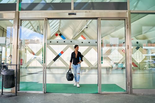 man-entering-modern-building-with-bag-2025-01-16-03-04-00-utc (1).jpg