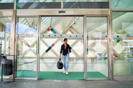 man-entering-modern-building-with-bag-2025-01-16-03-04-00-utc (1).jpg